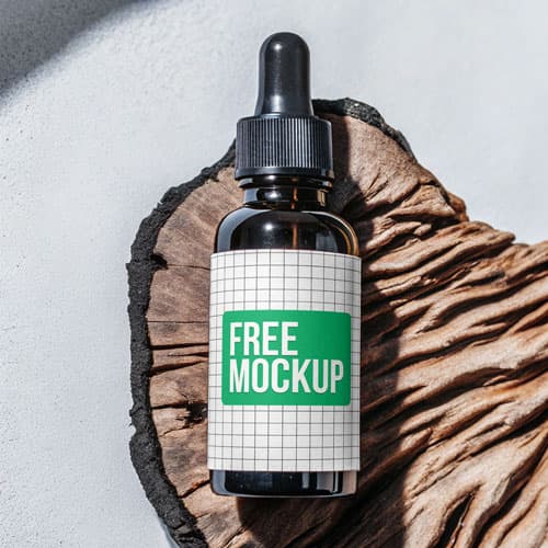 Free Amber Dropper Bottle PSD Mockup — Rustic Wood Slice