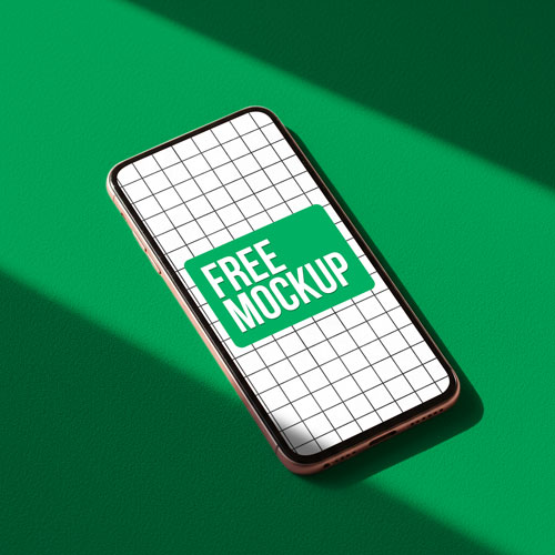 Free Smartphone PSD Mockup on Green Surface — Minimalist Device Display PSD mockup for Adobe Photoshop